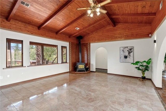 13155 San Antonio Rd, Atascadero, CA 93422 - empty room with wooden ceiling, a wood stove, ceiling fan, beam ceiling, and arched walkways