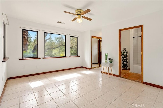 13155 San Antonio Rd, Atascadero, CA 93422 - empty room featuring a ceiling fan, light tile patterned floors, and baseboards