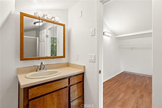 13155 San Antonio Rd, Atascadero, CA 93422 - bathroom with lofted ceiling, wood finished floors, and vanity