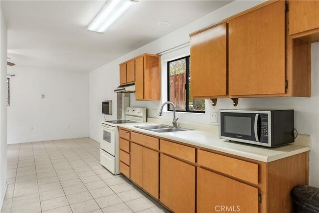 13155 San Antonio Rd, Atascadero, CA 93422 - kitchen featuring stainless steel microwave, electric stove, a sink, under cabinet range hood, and light countertops