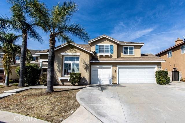 view of front facade featuring a tile roof, stucco siding, concrete driveway, and a garage