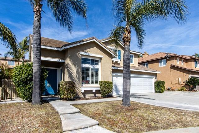 traditional-style house featuring stucco siding, a garage, and driveway