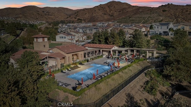 11636 Wandering Way, Corona, CA 92883 - pool at dusk with a pergola, fence, a patio, and a community pool