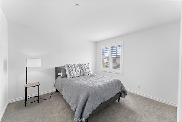 carpeted bedroom featuring baseboards
