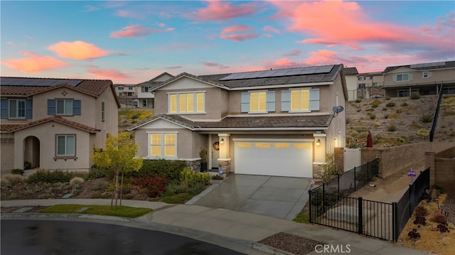 11636 Wandering Way, Corona, CA 92883 - view of front of home featuring stucco siding, solar panels, driveway, a garage, and stone siding