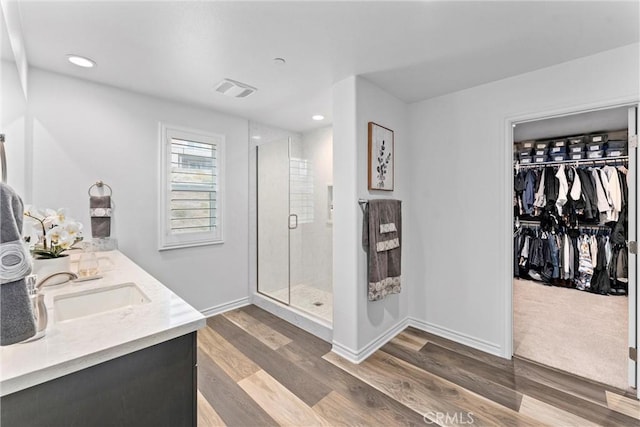 11636 Wandering Way, Corona, CA 92883 - full bath with a stall shower, wood finished floors, recessed lighting, baseboards, and double vanity