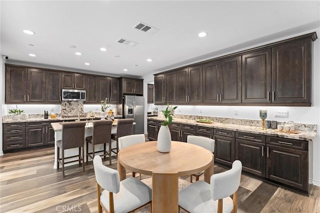 dining room featuring recessed lighting and light wood-style floors