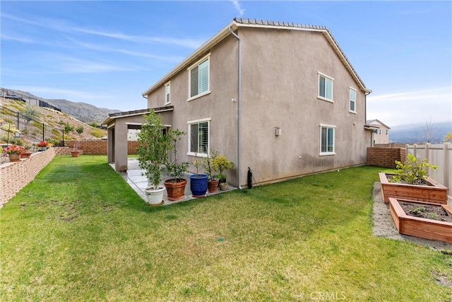 11636 Wandering Way, Corona, CA 92883 - back of house featuring a vegetable garden, stucco siding, a patio, and a mountain view