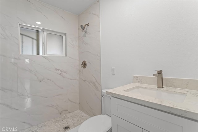 full bathroom featuring a marble finish shower, toilet, and vanity
