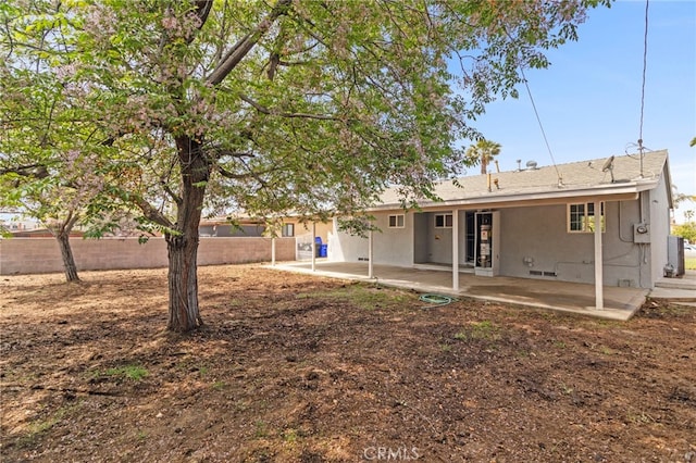 back of house with a patio area, fence, and crawl space