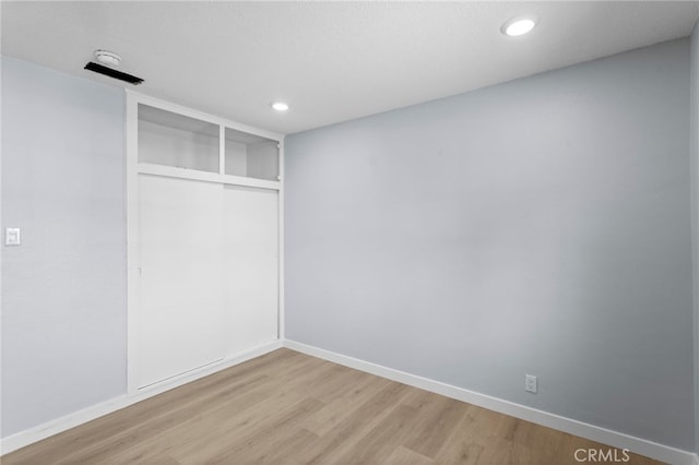 below grade area with baseboards, recessed lighting, and light wood-style floors