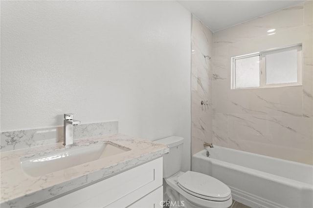 bathroom featuring vanity, bathtub / shower combination, and toilet