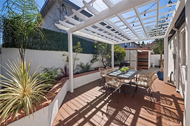 deck featuring outdoor dining area, a fenced backyard, and a pergola