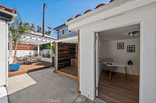 view of patio featuring fence and a pergola