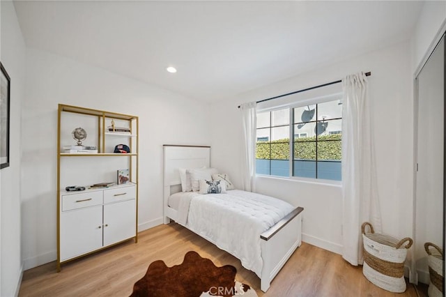 bedroom with recessed lighting, baseboards, and light wood-style floors