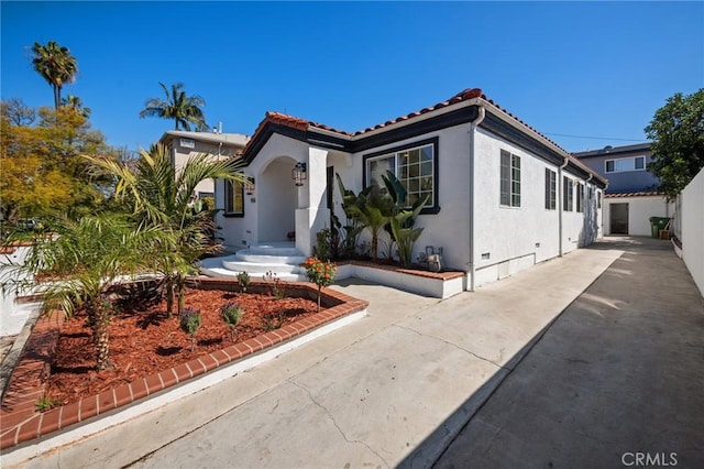mediterranean / spanish-style house with crawl space, stucco siding, and a tiled roof