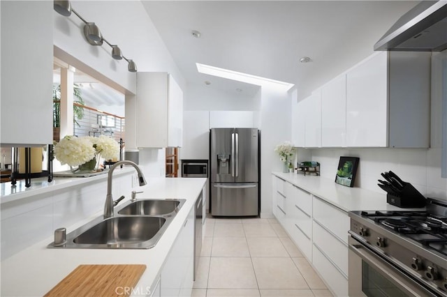 kitchen featuring a sink, light countertops, stainless steel appliances, and white cabinetry