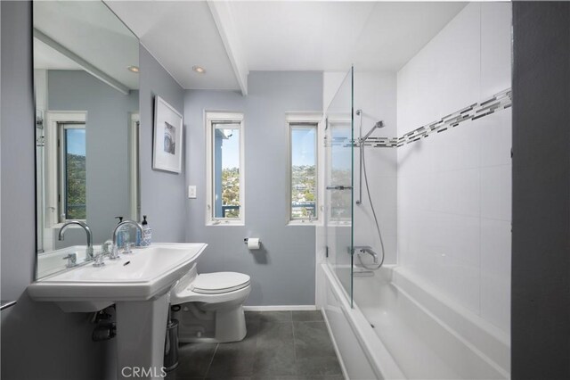 full bath featuring baseboards, tile patterned flooring, a healthy amount of sunlight, and toilet