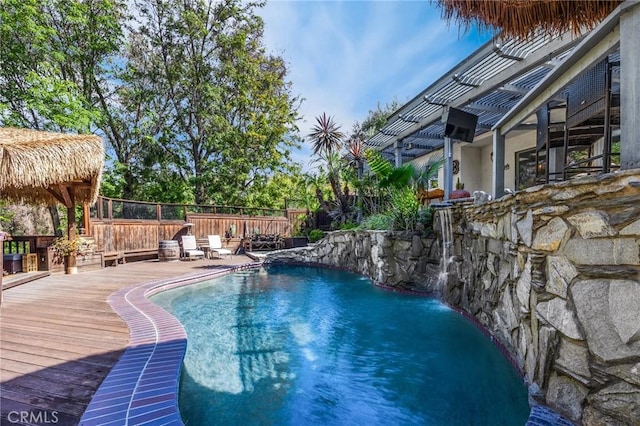 view of pool with a deck, a fenced in pool, and fence