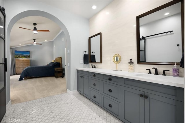 ensuite bathroom featuring recessed lighting, ensuite bath, a sink, and a ceiling fan