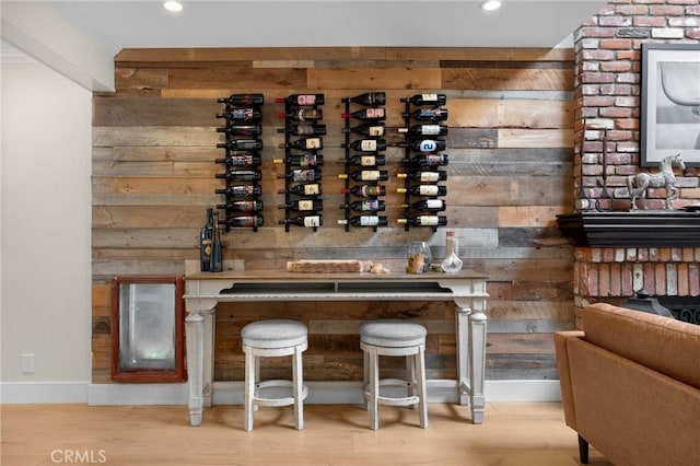 wine cellar featuring recessed lighting, wooden walls, and wood finished floors