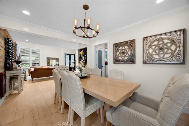 dining area with a chandelier, recessed lighting, and light wood-type flooring