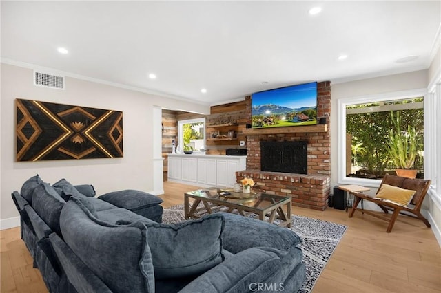 living area featuring plenty of natural light, visible vents, and recessed lighting