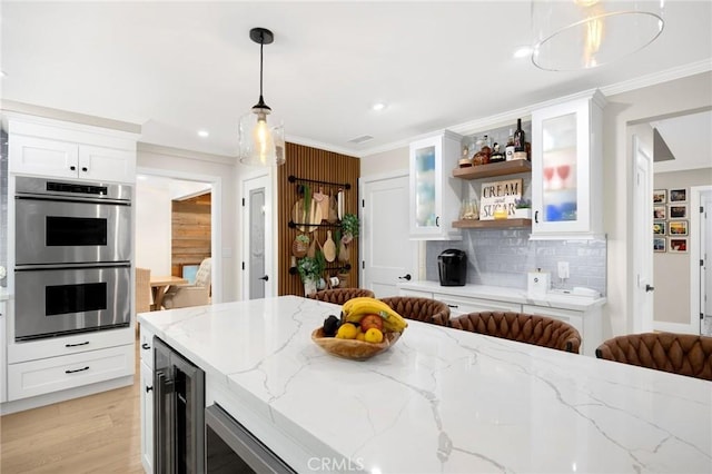 kitchen featuring crown molding, double oven, open shelves, beverage cooler, and backsplash