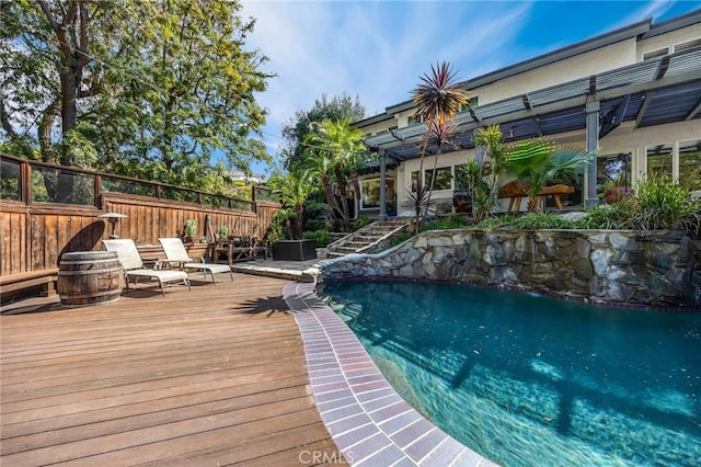 view of swimming pool with a pergola, fence, stairs, a fenced in pool, and a deck