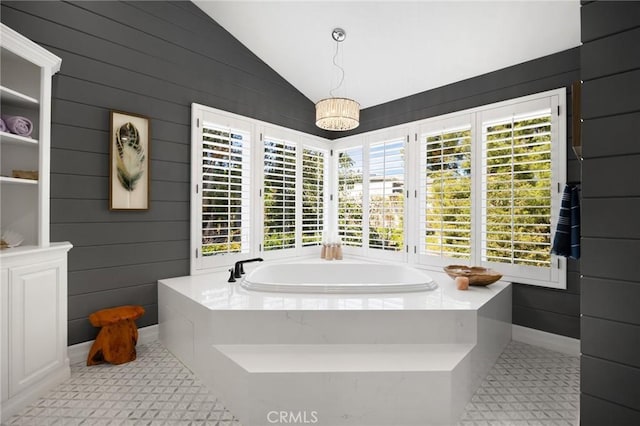 full bathroom with a bath and lofted ceiling