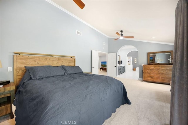 bedroom featuring arched walkways, carpet flooring, crown molding, and a ceiling fan