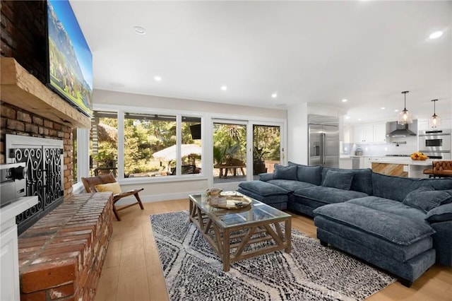 living room with light wood-style floors and recessed lighting