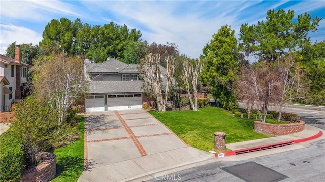traditional home with a chimney, concrete driveway, a garage, and a front lawn