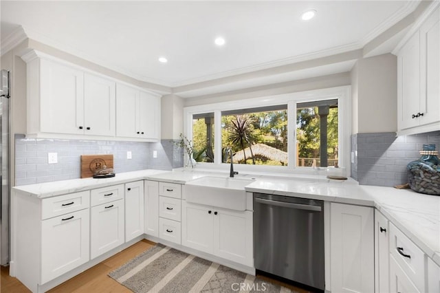 kitchen with light wood-style flooring, backsplash, light stone countertops, dishwasher, and a sink