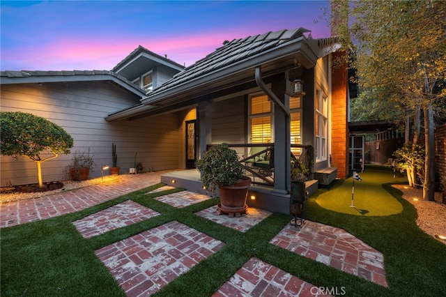 exterior space with a patio and a tile roof