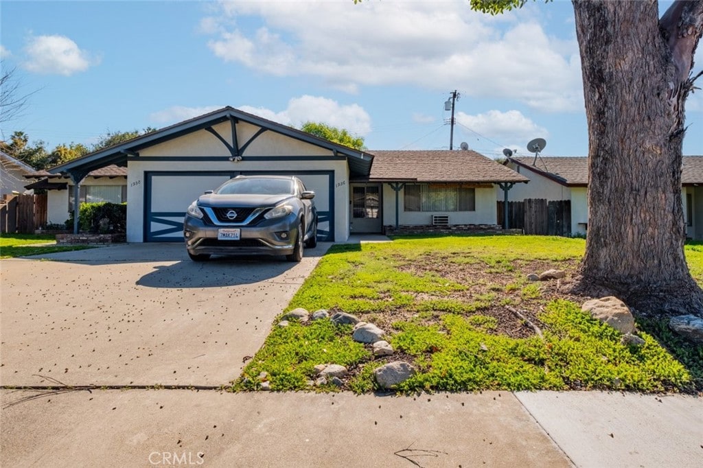 1936 Royalty Dr, Pomona, CA 91767 - ranch-style home with driveway, an attached garage, fence, and stucco siding