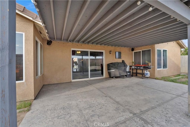view of patio featuring fence and area for grilling