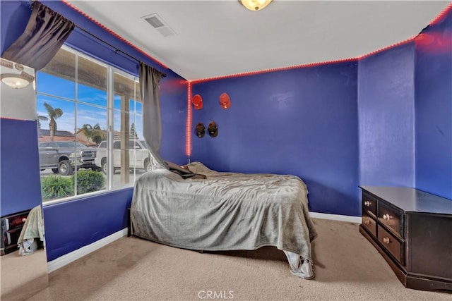 carpeted bedroom featuring baseboards and visible vents