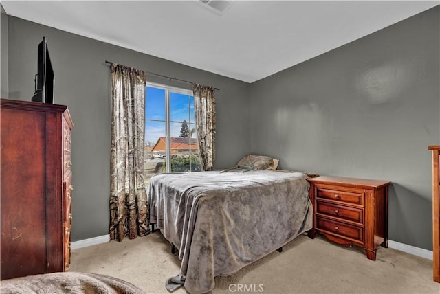 carpeted bedroom featuring visible vents and baseboards
