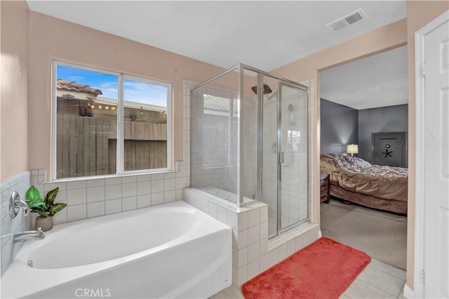 ensuite bathroom with a shower stall, a bath, ensuite bath, visible vents, and tile patterned flooring