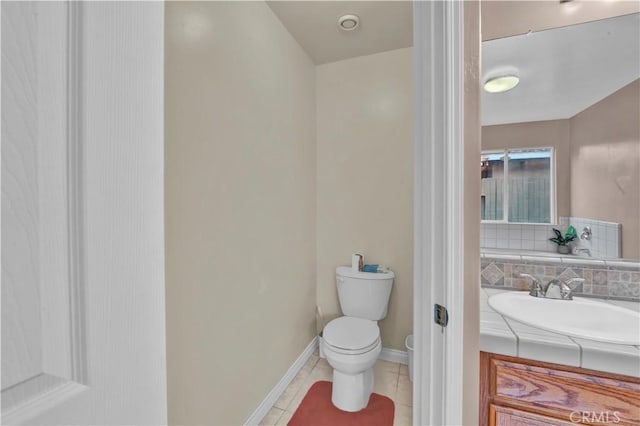 bathroom featuring tile patterned floors, vanity, toilet, and baseboards