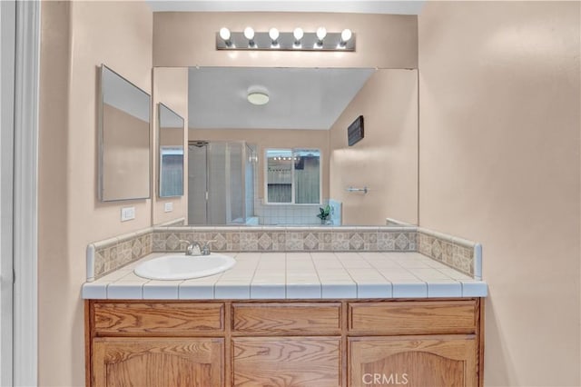 bathroom featuring a stall shower and vanity
