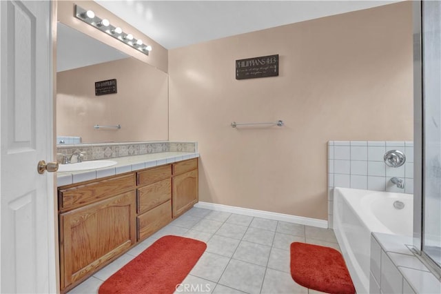 full bathroom featuring a garden tub, vanity, tile patterned flooring, and baseboards