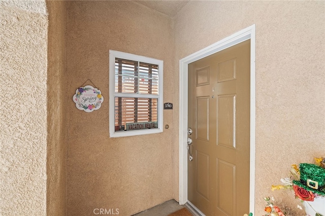 property entrance featuring stucco siding