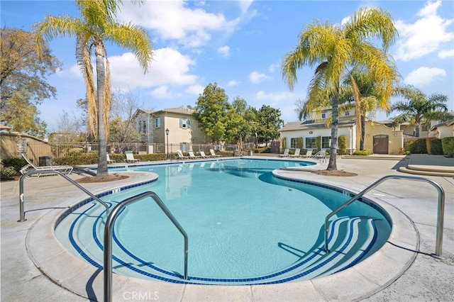 pool with fence and a patio