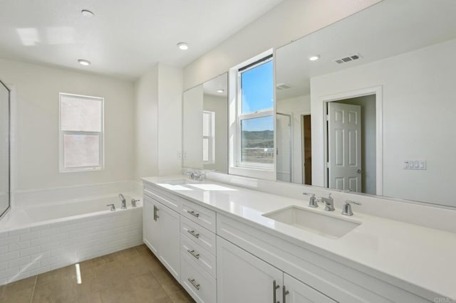 bathroom with a sink, visible vents, a bath, and tile patterned floors