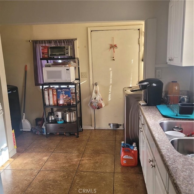 125 W Vernon Ave, Los Angeles, CA 90037 - kitchen featuring light countertops, white cabinets, white microwave, and tile patterned floors