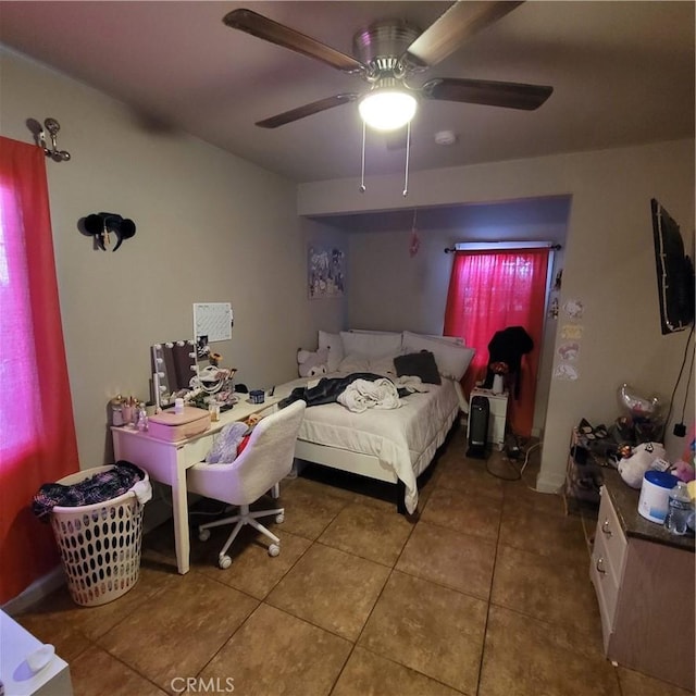 125 W Vernon Ave, Los Angeles, CA 90037 - tiled bedroom featuring a ceiling fan