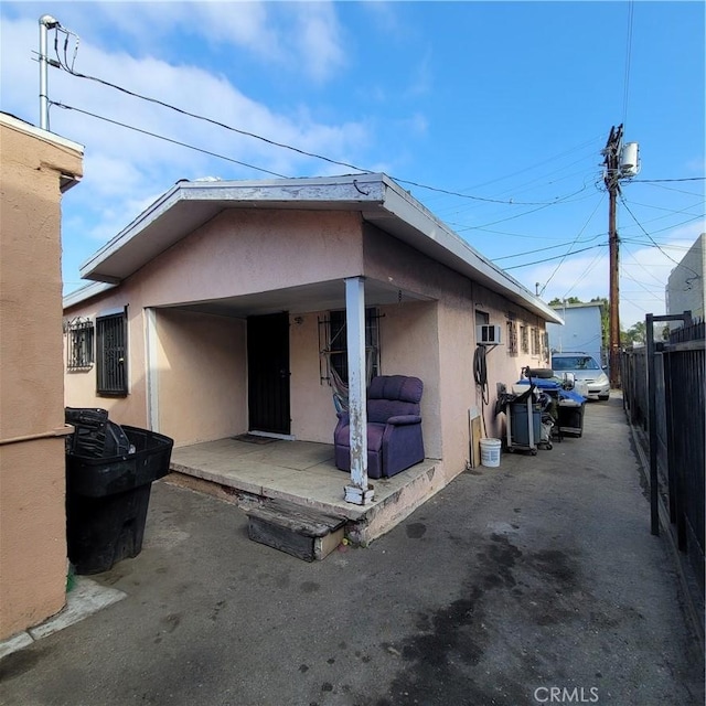 125 W Vernon Ave, Los Angeles, CA 90037 - back of property featuring stucco siding, fence, and a patio area