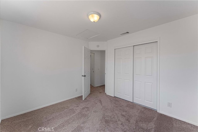 unfurnished bedroom with baseboards, carpet flooring, visible vents, and a closet